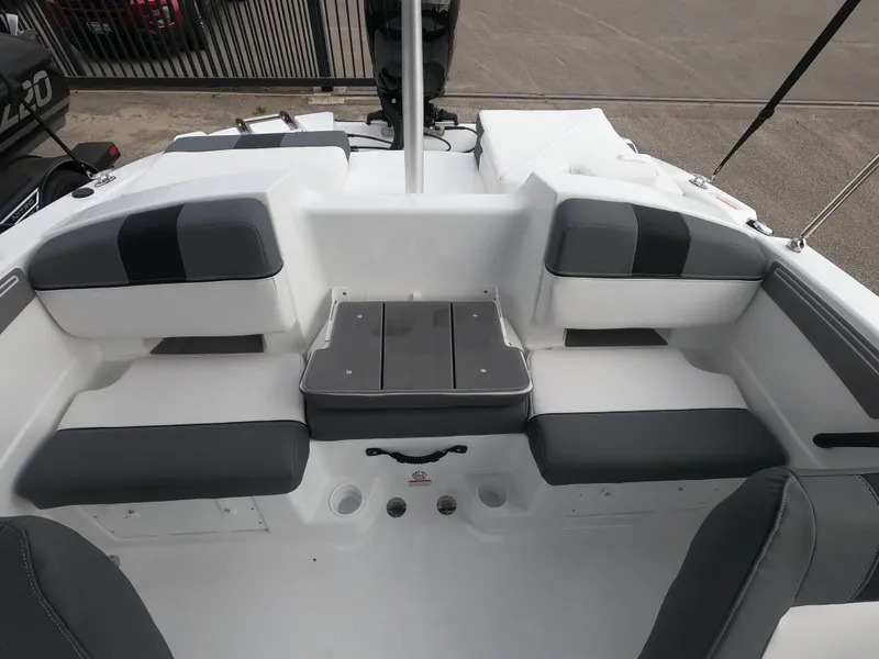 Slide: The Image of 2024 Tahoe T21 boat interior with cushioned seating and storage compartments. - 13