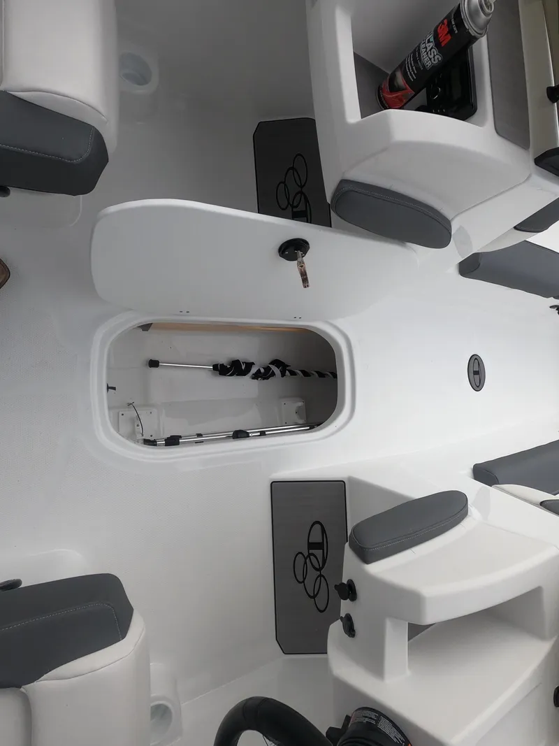 Slide: The Image of 2024 Tahoe T21 boat interior with storage compartments and seating. - 25