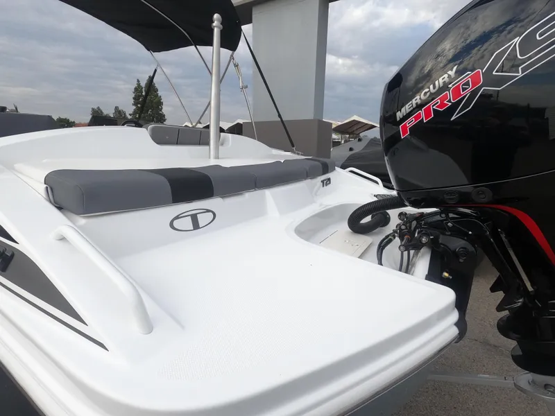 Slide: The Image of 2024 Tahoe T21 boat with Mercury Pro XS engine, rear seating, and swim platform. - 7