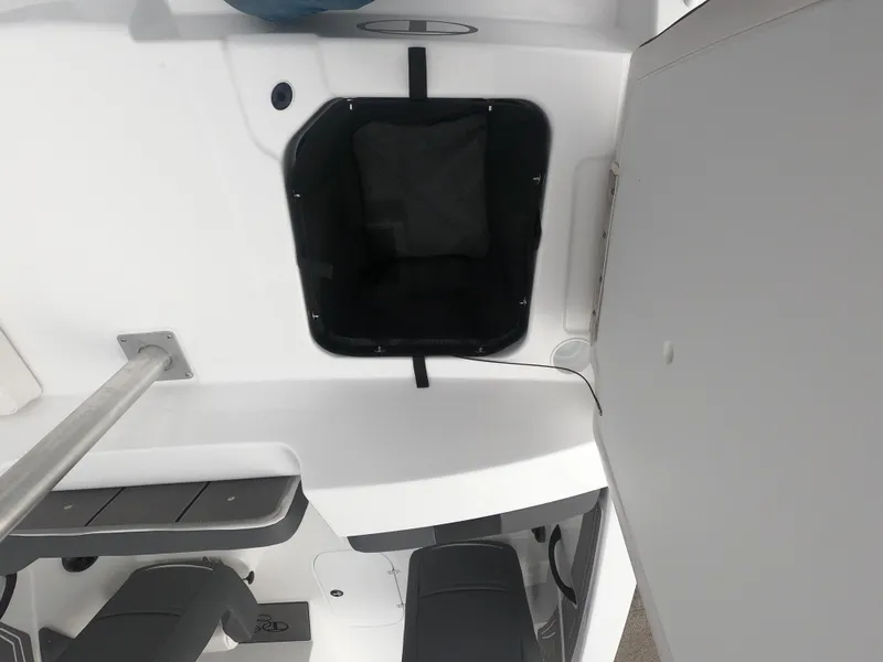 Slide: The Image of 2024 Tahoe T21 boat interior storage compartment and seating area. - 9