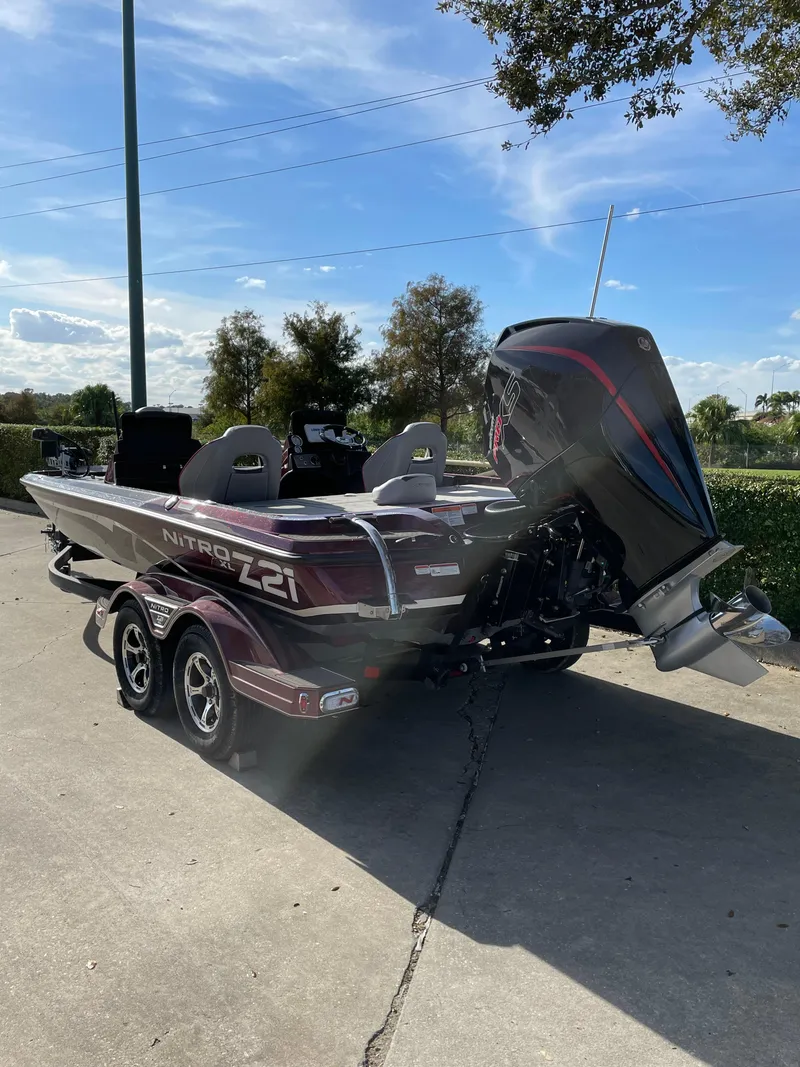 Slide: The Image of 2024 Nitro Z21 XL boat with powerful outboard motor on a trailer. - 2