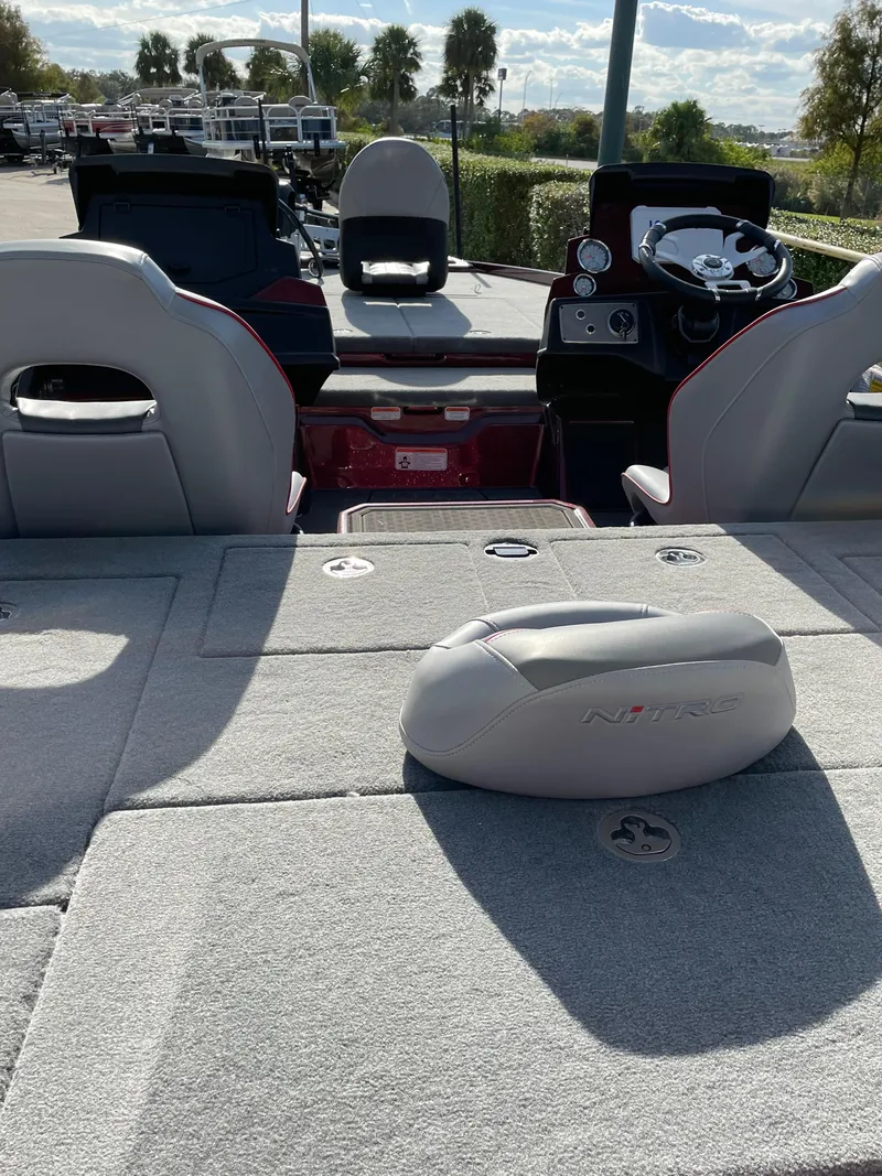 Slide: The Image of 2024 Nitro Z21 XL boat interior with steering console and seating. - 4
