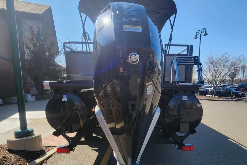 Slide: The Image of 2024 Regency 250 DL3 pontoon boat with powerful V8 engine, rear view. - 1