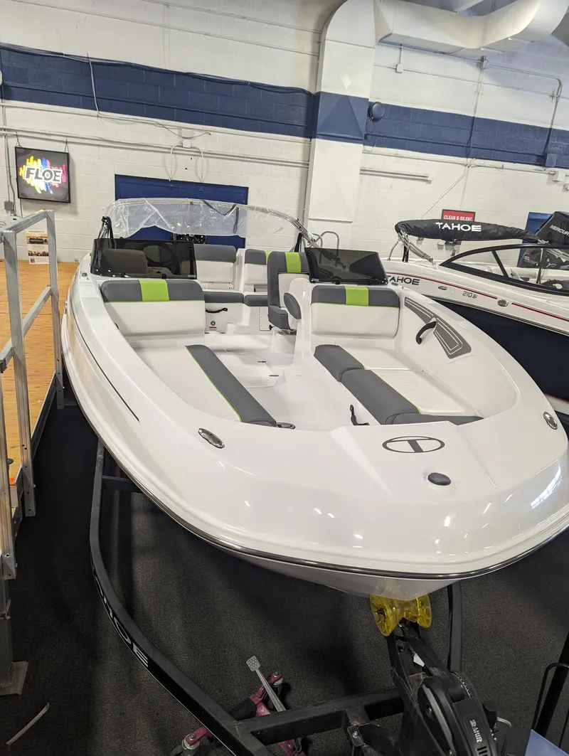 The Image of 2024 Tahoe T21 boat with sleek design and modern seating in showroom. - 0