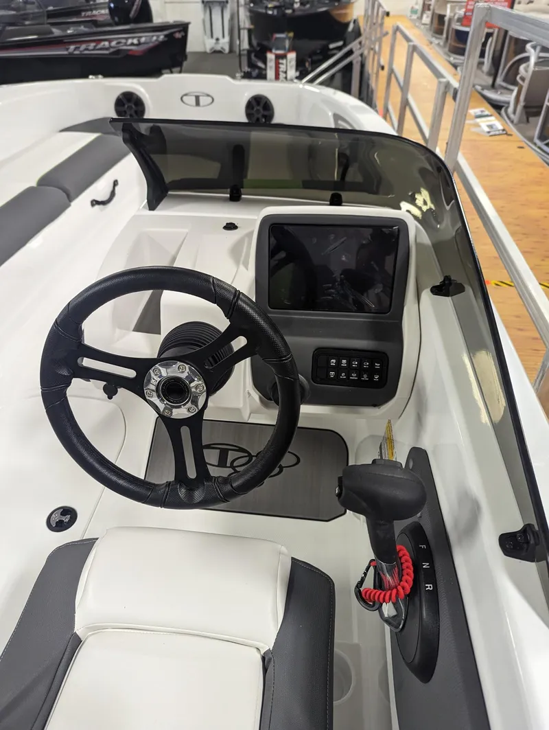Slide: The Image of 2024 Tahoe T21 boat cockpit with steering wheel and control panel. - 6