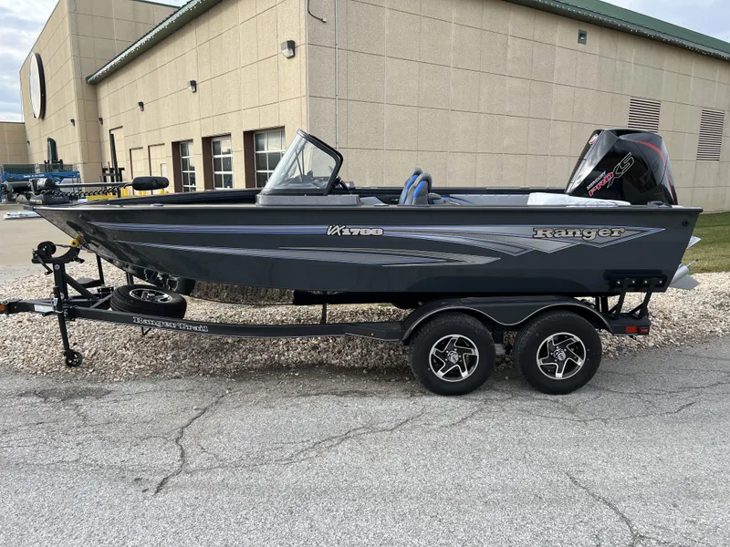 Slide: The Image of 2024 Ranger VX1788 WT fishing boat on a trailer outside a building. - 0