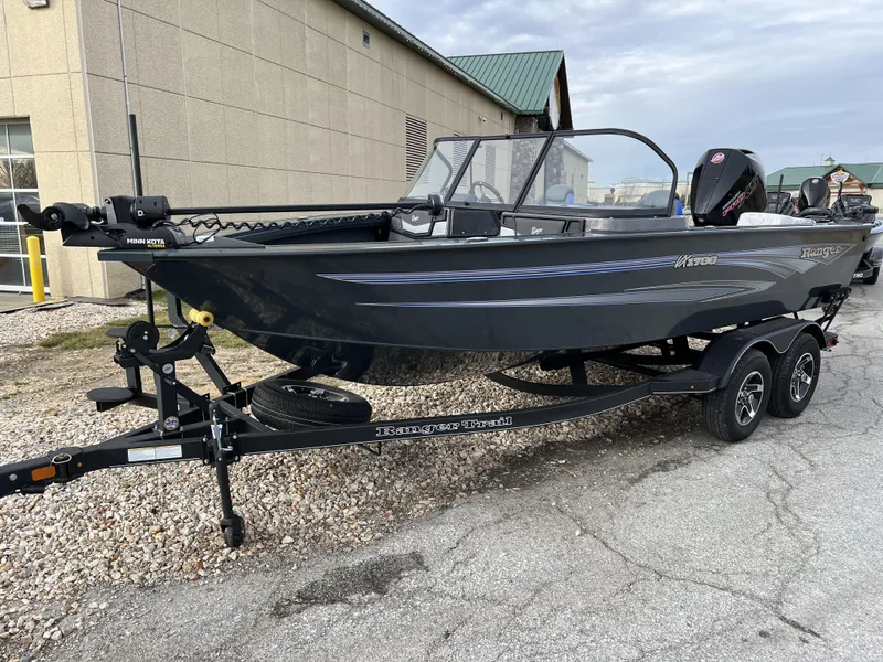 Slide: The Image of 2024 Ranger VX1788 WT fishing boat on a trailer outside a building. - 1