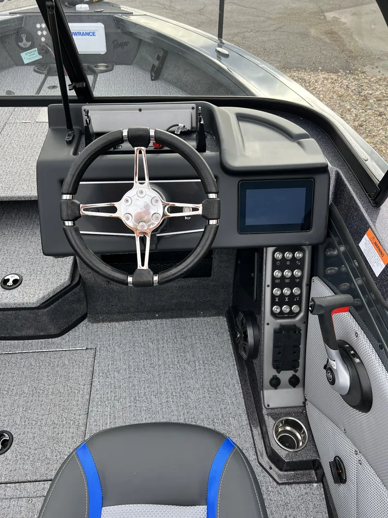 Slide: The Image of 2024 Ranger VX1788 WT boat dashboard with steering wheel and control panel. - 8