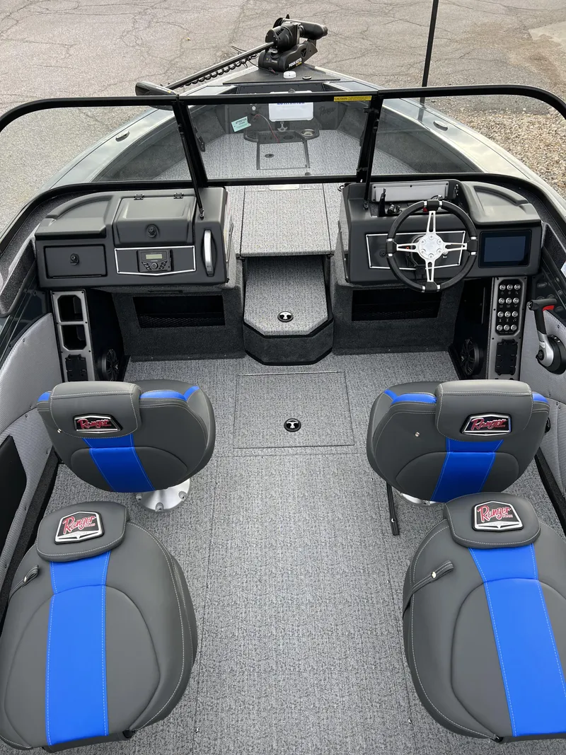 Slide: The Image of 2024 Ranger VX1788 WT boat interior with modern dashboard and blue-accented seats. - 9
