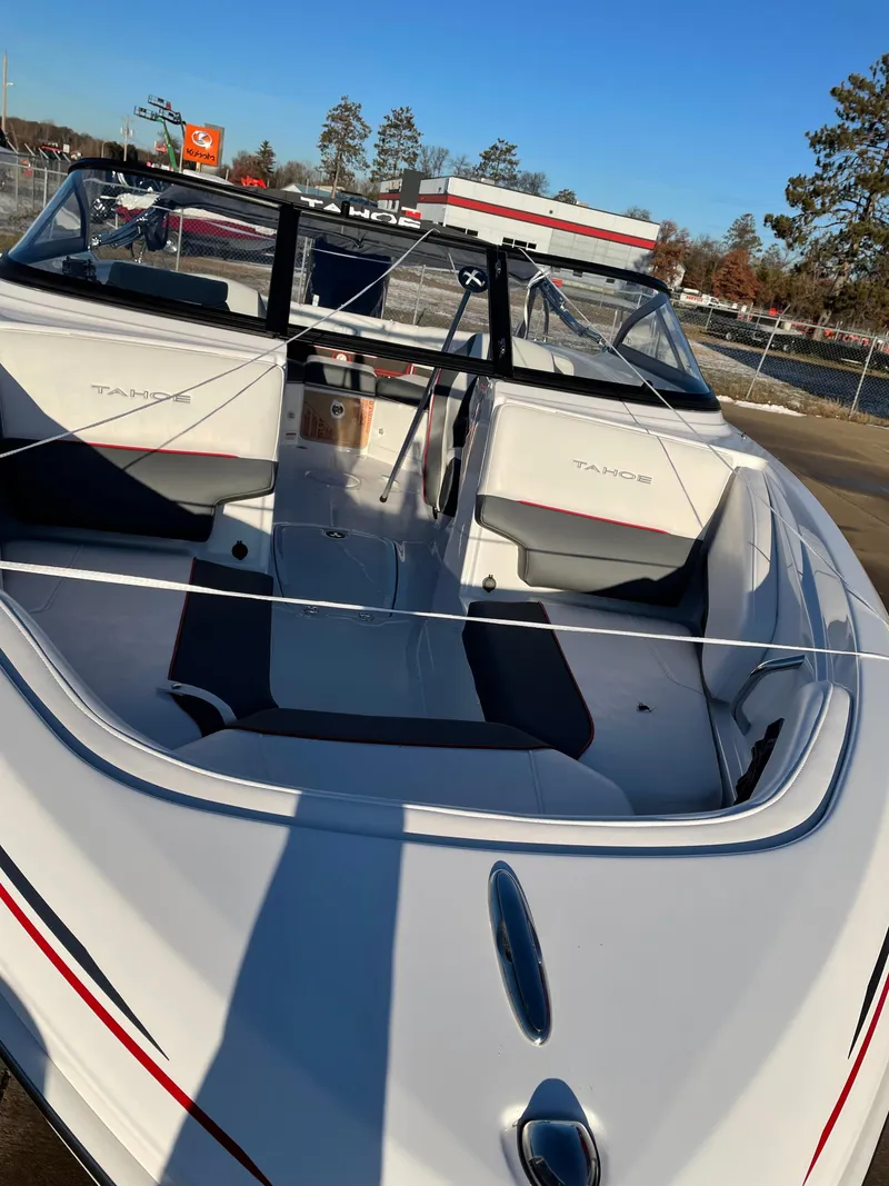 Slide: The Image of 2024 Tahoe 210 S boat, sleek white design, spacious seating, outdoor setting. - 3