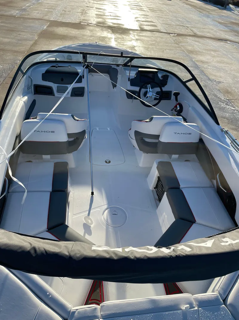 Slide: The Image of 2024 Tahoe 210 S boat interior with seating and steering wheel. - 4