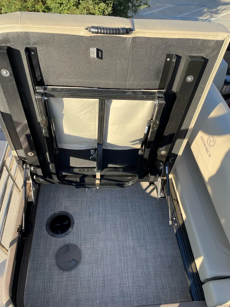 Slide: The Image of 2024 Regency 230 LE3 Sport boat interior with storage compartment. - 12