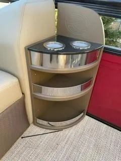 Slide: The Image of 2024 Regency 230 LE3 Sport boat interior with cup holders and storage compartments. - 5