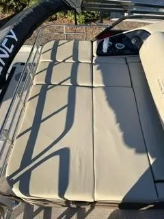 Slide: The Image of 2024 Regency 230 LE3 Sport boat with beige cushioned seating. - 7