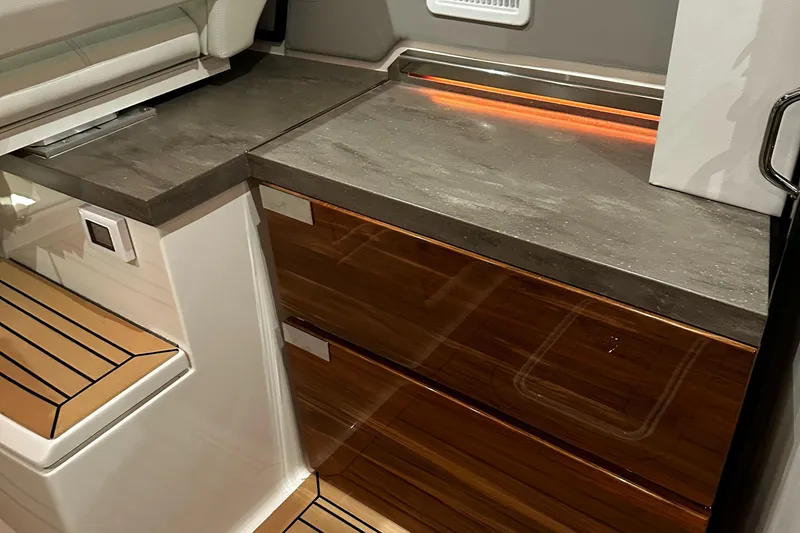 Slide: The Image of 2023 Tiara Yachts 43 LE interior with sleek countertops and wooden cabinetry. - 14