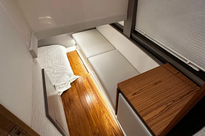 Slide: The Image of 2023 Tiara Yachts 43 LE interior with white seating and wooden flooring. - 8