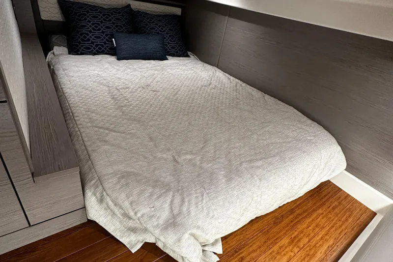 Slide: The Image of 2023 Tiara Yachts 43 LE cabin with cozy bed and modern decor. - 9