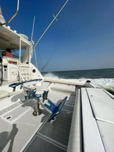 Slide: The Image of 1991 Tiara Yachts 4300 Open on open water, featuring fishing equipment and clear skies. - 14
