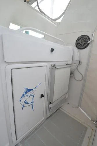 Slide: The Image of 1991 Tiara Yachts 4300 Open interior with marlin graphic and storage compartment. - 24