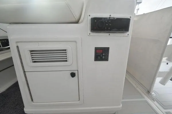 Slide: The Image of 1991 Tiara Yachts 4300 Open interior control panel and storage compartment. - 25