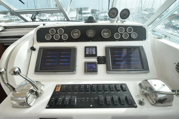 Slide: The Image of Control panel of a 1991 Tiara Yachts 4300 Open, featuring gauges and navigation screens. - 26