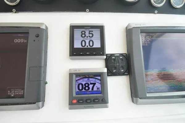 Slide: The Image of Control panel of a 1991 Tiara Yachts 4300 Open with navigation displays. - 31