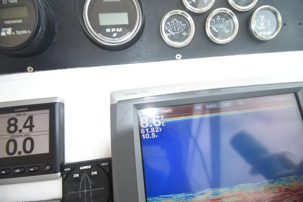 Slide: The Image of Dashboard of a 1991 Tiara Yachts 4300 Open with navigation and RPM gauges. - 33
