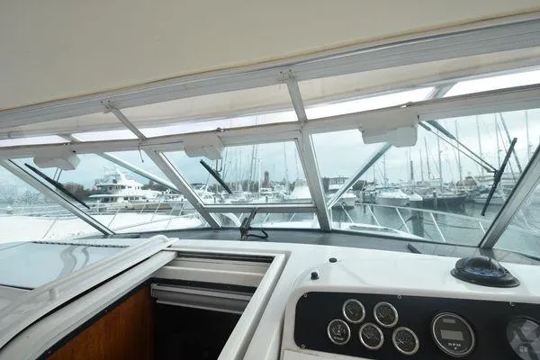 Slide: The Image of 1991 Tiara Yachts 4300 Open cockpit view with marina in background. - 34