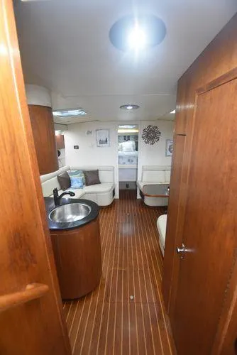 Slide: The Image of 1991 Tiara Yachts 4300 Open interior with wood finish and seating area. - 36