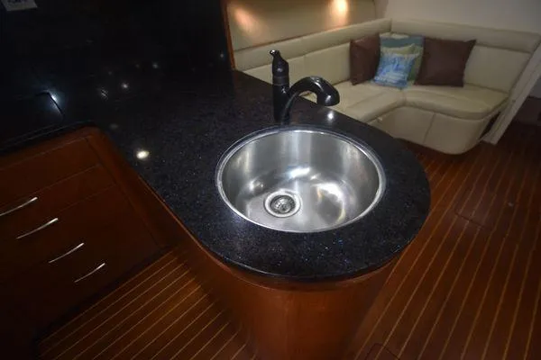 Slide: The Image of Luxurious 1991 Tiara Yachts 4300 Open interior with sleek kitchen sink and cozy seating area. - 39