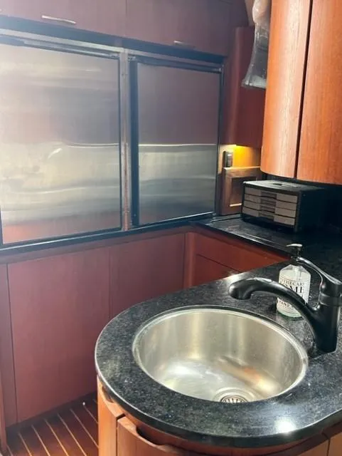 Slide: The Image of 1991 Tiara Yachts 4300 Open kitchen with stainless steel appliances and round sink. - 41