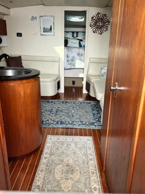 Slide: The Image of Interior of 1991 Tiara Yachts 4300 Open, featuring wood finishes and cozy seating area. - 42