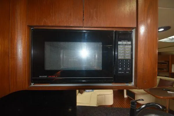 Slide: The Image of Microwave in 1991 Tiara Yachts 4300 Open, wooden cabinetry, interior view. - 44