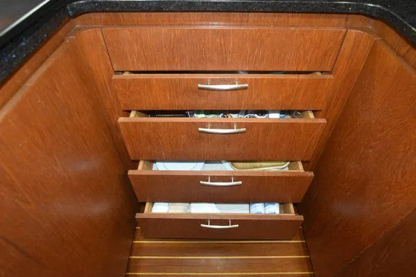 Slide: The Image of Wooden drawers in a 1991 Tiara Yachts 4300 Open, featuring sleek metal handles. - 48