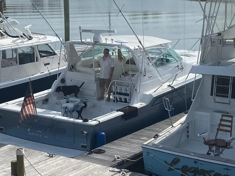 Slide: The Image of 1991 Tiara Yachts 4300 Open docked with people on board, Suffolk, VA. - 6