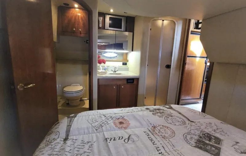 Slide: The Image of Interior of 2003 Cruisers Yachts 4370 Express with bed, bathroom, and kitchenette. - 13