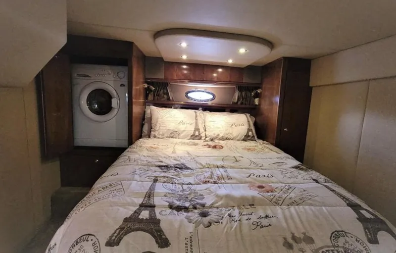 Slide: The Image of Luxurious 2003 Cruisers Yachts 4370 Express cabin with bed and washer-dryer unit. - 14