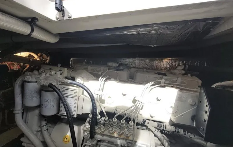 Slide: The Image of Engine compartment of 2003 Cruisers Yachts 4370 Express, showcasing mechanical components and wiring. - 15