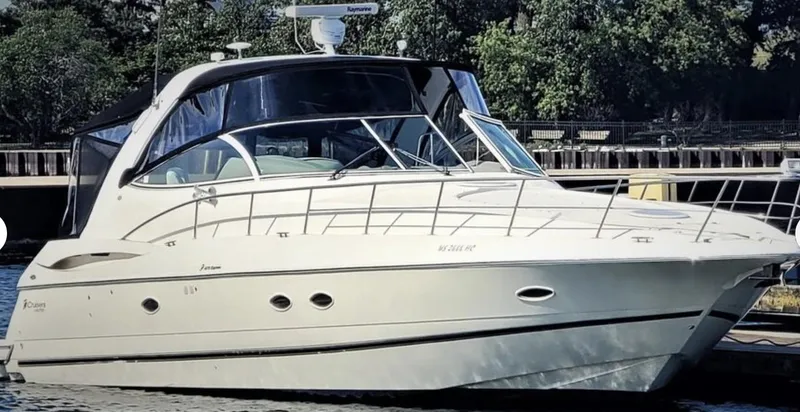 Slide: The Image of 2003 Cruisers Yachts 4370 Express boat docked, featuring sleek design and modern amenities. - 18