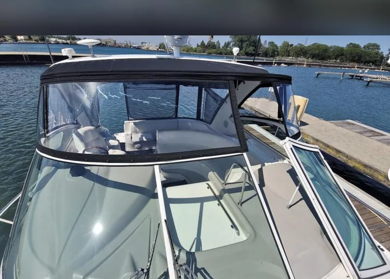 Slide: The Image of 2003 Cruisers Yachts 4370 Express docked at marina, featuring sleek design and spacious cockpit. - 2