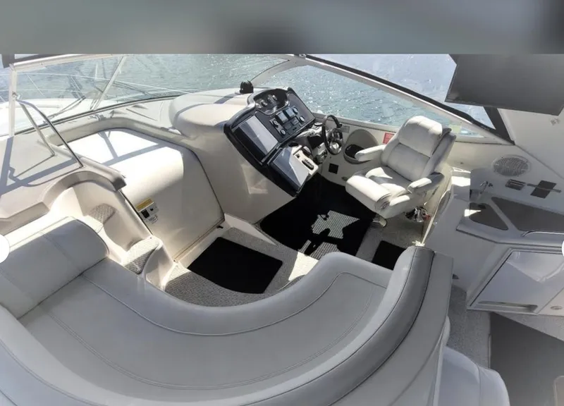 Slide: The Image of 2003 Cruisers Yachts 4370 Express cockpit with modern helm and seating. - 4