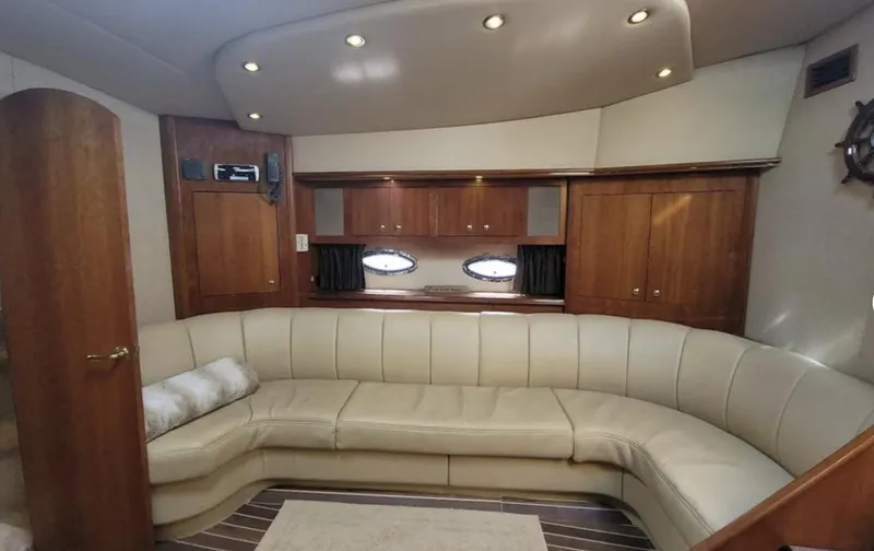 Slide: The Image of Luxurious interior of 2003 Cruisers Yachts 4370 Express with leather seating and wooden cabinetry. - 9