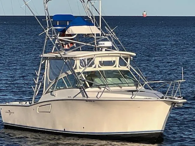 The Image of 2005 Albemarle 310 Express Fisherman boat docked in a marina under cloudy skies. - 0