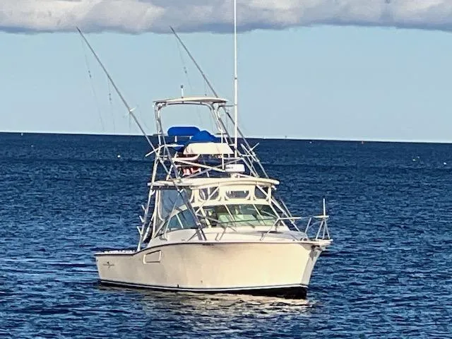 Slide: The Image of 2005 Albemarle 310 Express Fisherman boat on open water. - 2