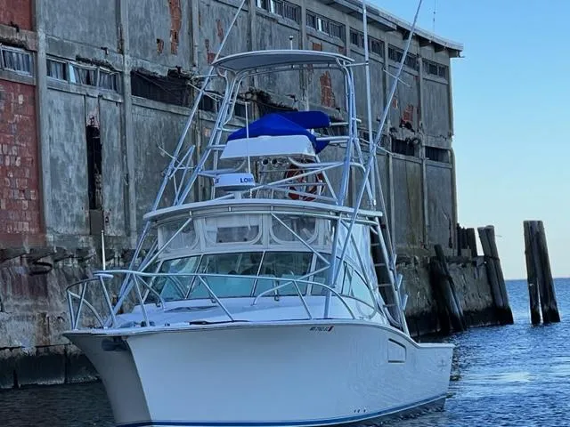 Slide: The Image of 2005 Albemarle 310 Express Fisherman boat on open water. - 4