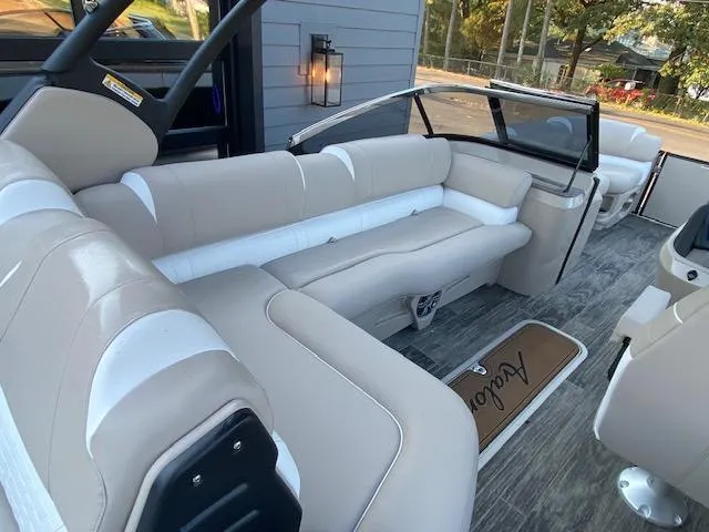 Slide: The Image of 2024 Avalon Catalina 2585 VRB boat interior with beige and white seating. - 12