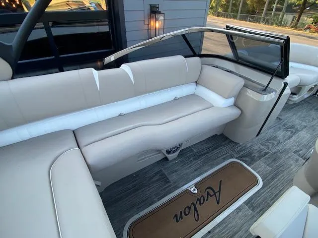 Slide: The Image of Interior of 2024 Avalon Catalina 2585 VRB boat with beige seating and wood flooring. - 16