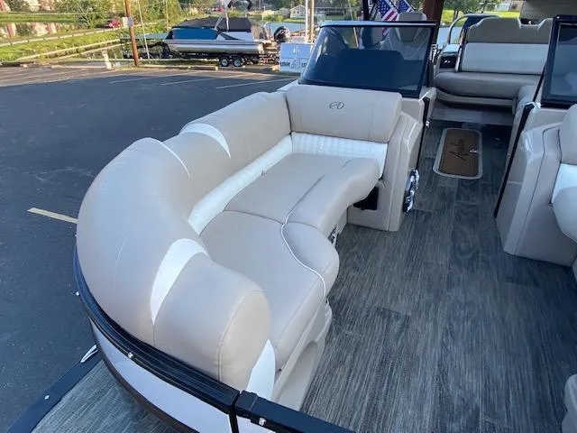 Slide: The Image of 2024 Avalon Catalina 2585 VRB boat interior with beige seating and wood flooring. - 20