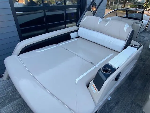 Slide: The Image of 2024 Avalon Catalina 2585 VRB boat with luxurious beige seating and cup holders. - 22