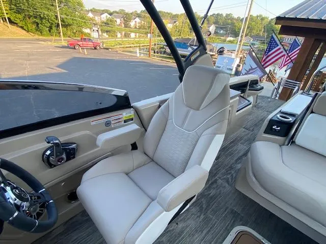 Slide: The Image of 2024 Avalon Catalina 2585 VRB boat interior with captain's chair and steering console. - 5
